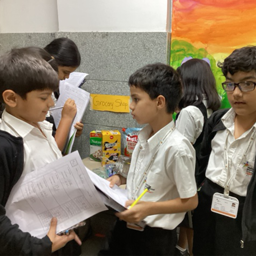 Participants collaborating on math problems at Nahar School